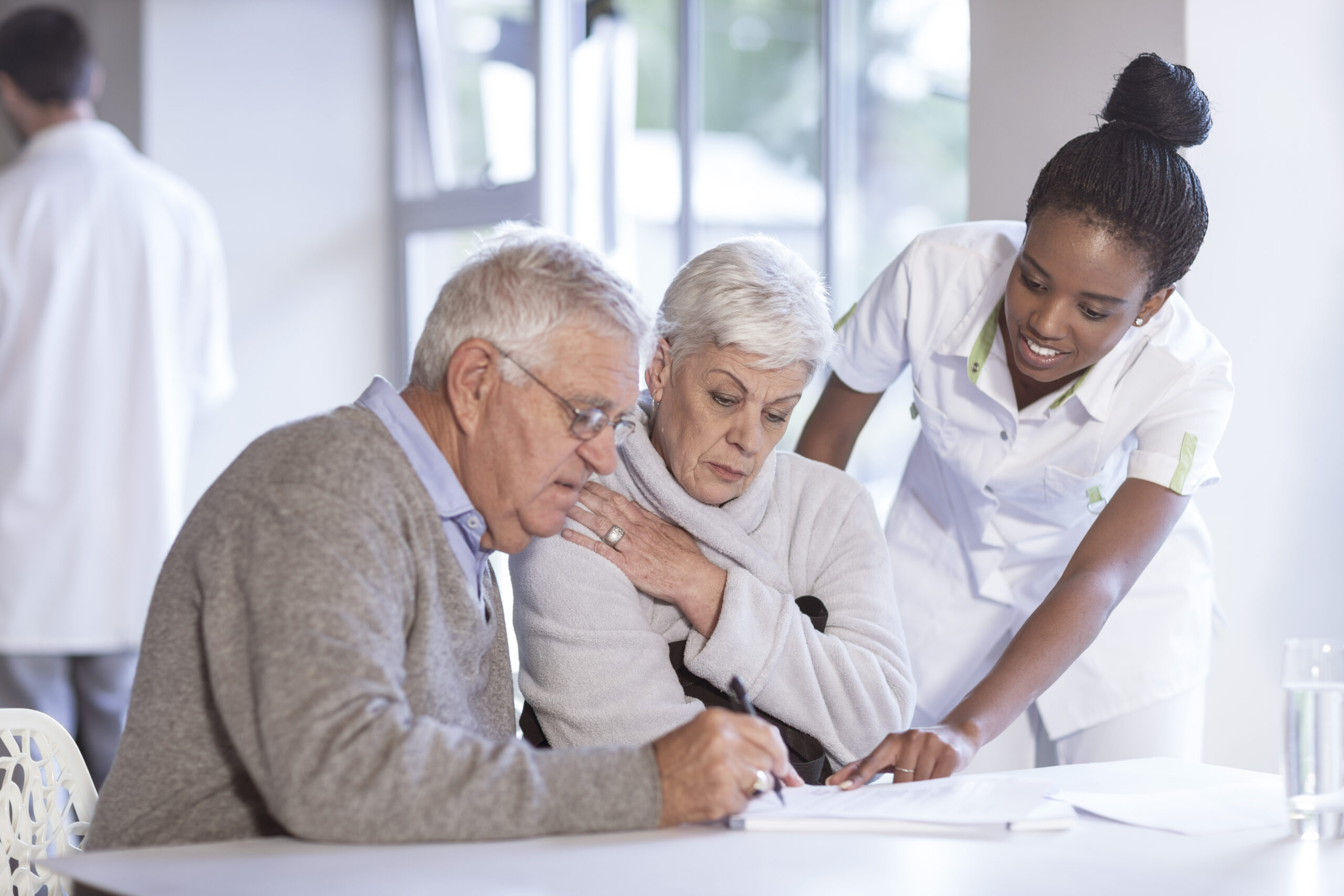 Nurse caring for senior couple